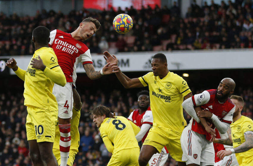 Arsenal's English defender Ben White (2nd L) jumps to win a header during the English Premier League football match between Arsenal and Brentford at the Emirates Stadium in London on February 19, 2022. - - RESTRICTED TO EDITORIAL USE. No use with unauthorized audio, video, data, fixture lists, club/league logos or 'live' services. Online in-match use limited to 120 images. An additional 40 images may be used in extra time. No video emulation. Social media in-match use limited to 120 images. An additional 40 images may be used in extra time. No use in betting publications, games or single club/league/player publications. (Photo by Ian KINGTON / AFP) / RESTRICTED TO EDITORIAL USE. No use with unauthorized audio, video, data, fixture lists, club/league logos or 'live' services. Online in-match use limited to 120 images. An additional 40 images may be used in extra time. No video emulation. Social media in-match use limited to 120 images. An additional 40 images may be used in extra time. No use in betting publications, games or single club/league/player publications. / RESTRICTED TO EDITORIAL USE. No use with unauthorized audio, video, data, fixture lists, club/league logos or 'live' services. Online in-match use limited to 120 images. An additional 40 images may be used in extra time. No video emulation. Social media in-match use limited to 120 images. An additional 40 images may be used in extra time. No use in betting publications, games or single club/league/player publications. (Photo by IAN KINGTON/AFP via Getty Images)