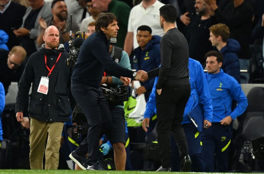 Tottenham Hotspur's Italian head coach Antonio Conte (L) shakes hands with Arsenal's Spanish manager Mikel Arteta (R) after the English Premier League football match between Tottenham Hotspur and Arsenal at Tottenham Hotspur Stadium in London, on May 12, 2022. - Tottenham won the game 3-0. - RESTRICTED TO EDITORIAL USE. No use with unauthorized audio, video, data, fixture lists, club/league logos or 'live' services. Online in-match use limited to 120 images. An additional 40 images may be used in extra time. No video emulation. Social media in-match use limited to 120 images. An additional 40 images may be used in extra time. No use in betting publications, games or single club/league/player publications. (Photo by Glyn KIRK / AFP) / RESTRICTED TO EDITORIAL USE. No use with unauthorized audio, video, data, fixture lists, club/league logos or 'live' services. Online in-match use limited to 120 images. An additional 40 images may be used in extra time. No video emulation. Social media in-match use limited to 120 images. An additional 40 images may be used in extra time. No use in betting publications, games or single club/league/player publications. / RESTRICTED TO EDITORIAL USE. No use with unauthorized audio, video, data, fixture lists, club/league logos or 'live' services. Online in-match use limited to 120 images. An additional 40 images may be used in extra time. No video emulation. Social media in-match use limited to 120 images. An additional 40 images may be used in extra time. No use in betting publications, games or single club/league/player publications. (Photo by GLYN KIRK/AFP via Getty Images)