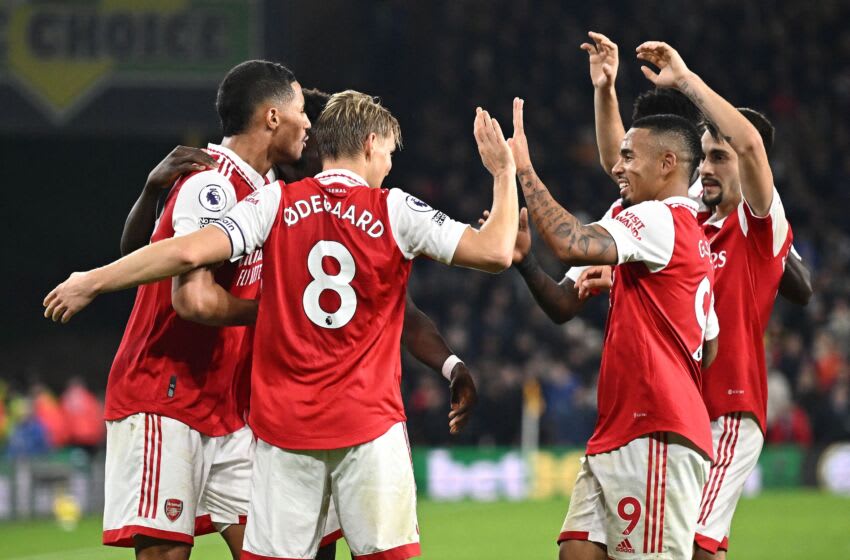 Arsenal's Norwegian midfielder Martin Odegaard celebrates scoring his team's second goal with teammates during the English Premier League football match between Wolverhampton Wanderers and Arsenal at the Molineux stadium in Wolverhampton, central England on November 12, 2022. - RESTRICTED TO EDITORIAL USE. No use with unauthorized audio, video, data, fixture lists, club/league logos or 'live' services. Online in-match use limited to 120 images. An additional 40 images may be used in extra time. No video emulation. Social media in-match use limited to 120 images. An additional 40 images may be used in extra time. No use in betting publications, games or single club/league/player publications. (Photo by Oli SCARFF / AFP) / RESTRICTED TO EDITORIAL USE. No use with unauthorized audio, video, data, fixture lists, club/league logos or 'live' services. Online in-match use limited to 120 images. An additional 40 images may be used in extra time. No video emulation. Social media in-match use limited to 120 images. An additional 40 images may be used in extra time. No use in betting publications, games or single club/league/player publications. / RESTRICTED TO EDITORIAL USE. No use with unauthorized audio, video, data, fixture lists, club/league logos or 'live' services. Online in-match use limited to 120 images. An additional 40 images may be used in extra time. No video emulation. Social media in-match use limited to 120 images. An additional 40 images may be used in extra time. No use in betting publications, games or single club/league/player publications. (Photo by OLI SCARFF/AFP via Getty Images)
