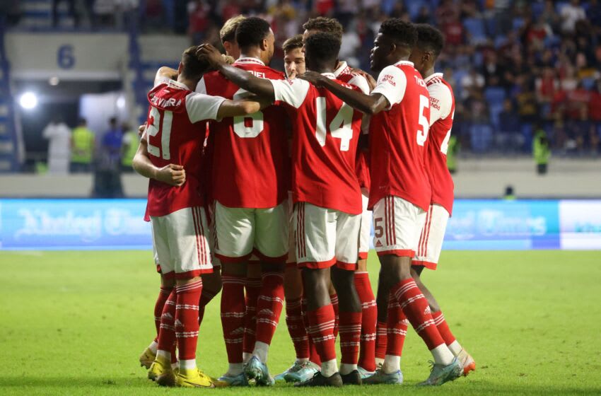Arsenal's players gather in a huddle as they celebrate scoring during the AC Milan and Arsenal friendly match at the Dubai Super Cup 2022, at the al-Maktoum stadium in the Gulf emirate, on December 13, 2022. (Photo by KARIM SAHIB / AFP) (Photo by KARIM SAHIB/AFP via Getty Images)