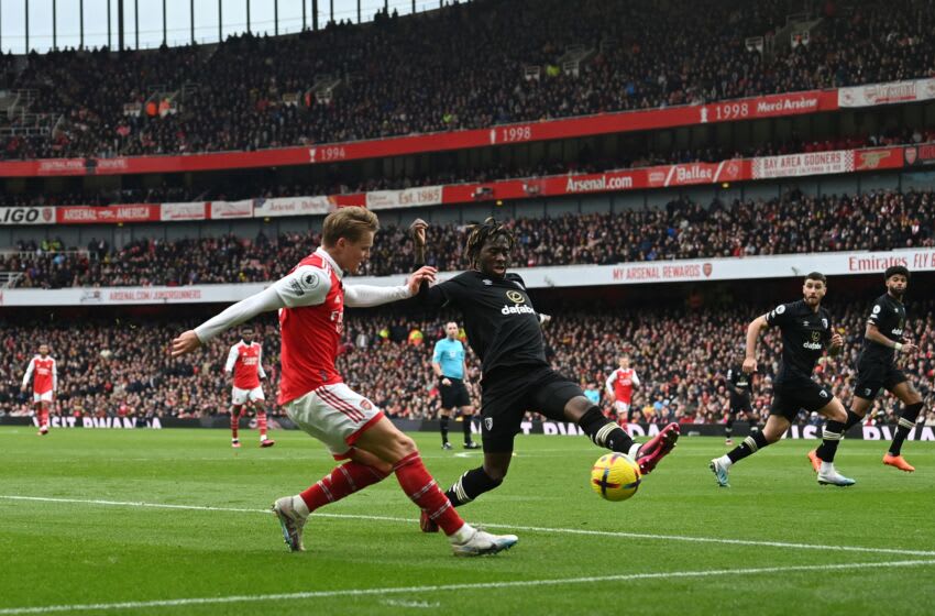 Arsenal's Norwegian midfielder Martin Odegaard (L) fights for the ball with Bournemouth's English defender Jordan Zemura during the English Premier League football match between Arsenal and Bournemouth at the Emirates Stadium in London on March 4, 2023. (Photo by Glyn KIRK / AFP) / RESTRICTED TO EDITORIAL USE. No use with unauthorized audio, video, data, fixture lists, club/league logos or 'live' services. Online in-match use limited to 120 images. An additional 40 images may be used in extra time. No video emulation. Social media in-match use limited to 120 images. An additional 40 images may be used in extra time. No use in betting publications, games or single club/league/player publications. / (Photo by GLYN KIRK/AFP via Getty Images)
