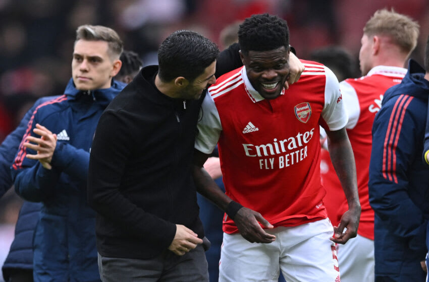 Arsenal's Spanish manager Mikel Arteta (2L) shares a joke with Arsenal's Ghanaian midfielder Thomas Partey (2R) on the pitch after the English Premier League football match between Arsenal and Crystal Palace at the Emirates Stadium in London on March 19, 2023. - Arsenal won the game 4-1. (Photo by JUSTIN TALLIS / AFP) / RESTRICTED TO EDITORIAL USE. No use with unauthorized audio, video, data, fixture lists, club/league logos or 'live' services. Online in-match use limited to 120 images. An additional 40 images may be used in extra time. No video emulation. Social media in-match use limited to 120 images. An additional 40 images may be used in extra time. No use in betting publications, games or single club/league/player publications. / (Photo by JUSTIN TALLIS/AFP via Getty Images)