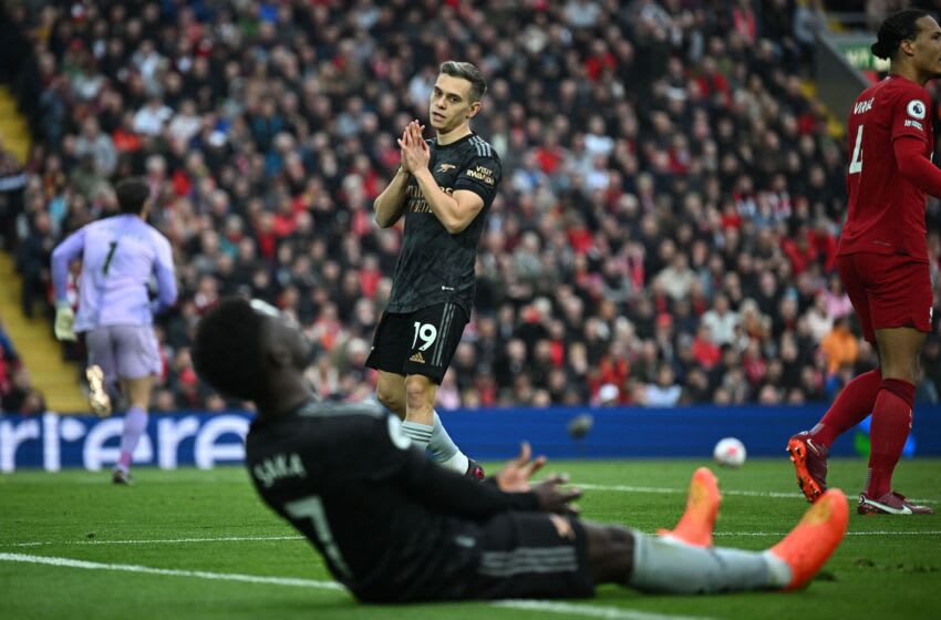Arsenal's Belgian midfielder Leandro Trossard (C) reacts after failing to connect with a cross from Arsenal's English midfielder Bukayo Saka during the English Premier League football match between Liverpool and Arsenal at Anfield in Liverpool, north west England on April 9, 2023. (Photo by Paul ELLIS / AFP) / RESTRICTED TO EDITORIAL USE. No use with unauthorized audio, video, data, fixture lists, club/league logos or 'live' services. Online in-match use limited to 120 images. An additional 40 images may be used in extra time. No video emulation. Social media in-match use limited to 120 images. An additional 40 images may be used in extra time. No use in betting publications, games or single club/league/player publications. / (Photo by PAUL ELLIS/AFP via Getty Images)