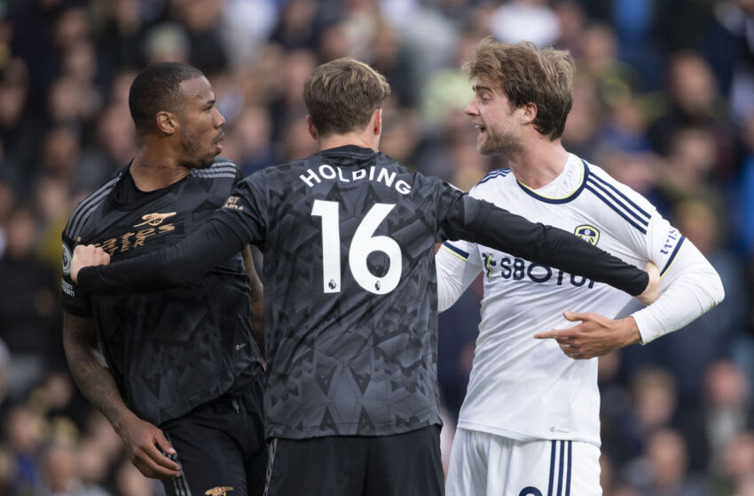 LEEDS, ENGLAND - OCTOBER 16: Rob Holding of Arsenal holds back team mate Gabriel Magalhaes and Patrick Bamford of Leeds United during the Premier League match between Leeds United and Arsenal FC at Elland Road on October 16, 2022 in Leeds, United Kingdom. (Photo by Joe Prior/Visionhaus via Getty Images)