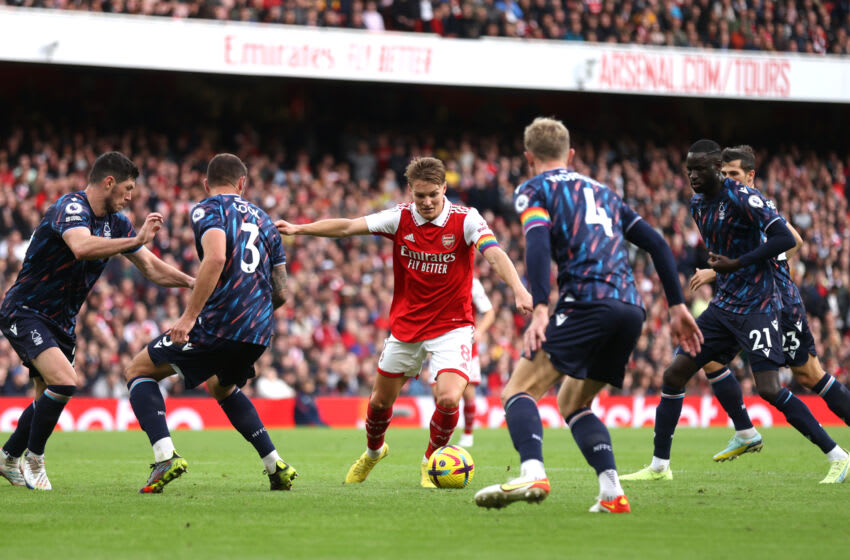 LONDON, ENGLAND - OCTOBER 30: Martin Odegaard is surrounded by Nottingham Forest players before scoring his sides fifth goal during the Premier League match between Arsenal FC and Nottingham Forest at Emirates Stadium on October 30, 2022 in London, England. (Photo by Alex Pantling/Getty Images)