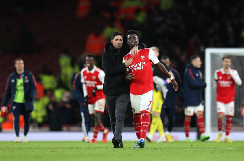 LONDON, ENGLAND - DECEMBER 26: Mikel Arteta, Manager of Arsenal embraces Bukayo Saka of Arsenal following the Premier League match between Arsenal FC and West Ham United at Emirates Stadium on December 26, 2022 in London, England. (Photo by Alex Pantling/Getty Images)