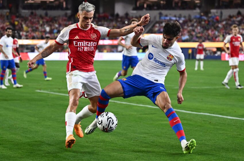 Arsenal's Belgian midfielder Leandro Trossard (L) and Barcelona's Moroccan forward Abde Ezzalzouli (R) vie for the ball during a pre-season friendly football match between Arsenal FC and FC Barcelona at SoFi Stadium in Inglewood, California, on July 26, 2023. (Photo by Patrick T. Fallon / AFP) (Photo by PATRICK T. FALLON/AFP via Getty Images)