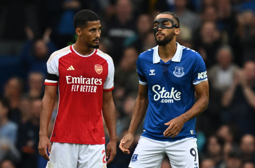 Arsenal's French defender #02 William Saliba (L) checks the facemask being worn by Everton's English striker #09 Dominic Calvert-Lewin (R) during the English Premier League football match between Everton and Arsenal at Goodison Park in Liverpool, north west England on September 17, 2023. (Photo by Paul ELLIS / AFP) / RESTRICTED TO EDITORIAL USE. No use with unauthorized audio, video, data, fixture lists, club/league logos or 'live' services. Online in-match use limited to 120 images. An additional 40 images may be used in extra time. No video emulation. Social media in-match use limited to 120 images. An additional 40 images may be used in extra time. No use in betting publications, games or single club/league/player publications. / (Photo by PAUL ELLIS/AFP via Getty Images)