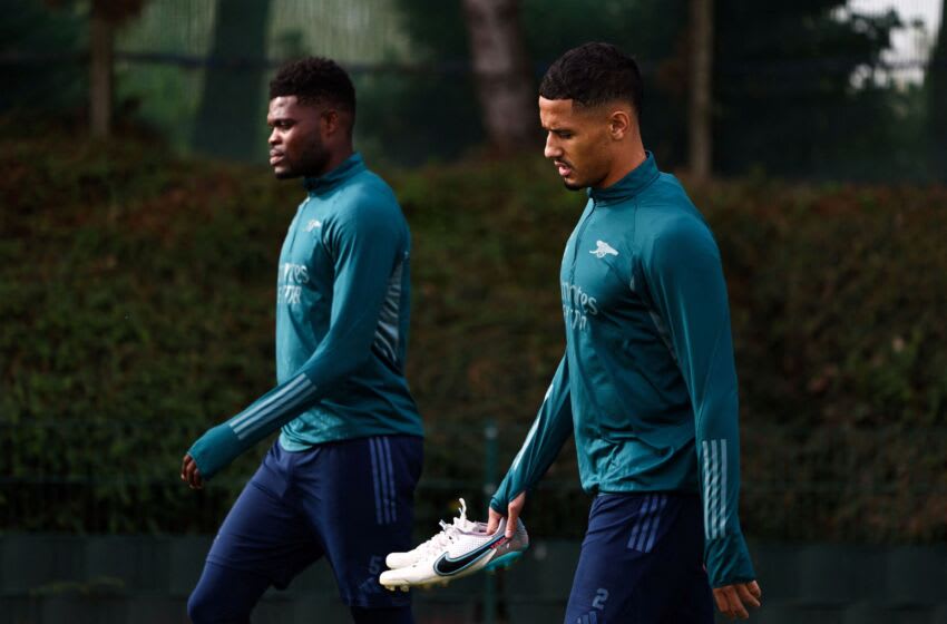 Arsenal's Ghanaian midfielder #05 Thomas Partey and Arsenal's French defender #02 William Saliba arrive to attend a team training session at Arsenal's training ground in north London on October 23, 2023, ahead of their UEFA Champions League Group B football match against Sevilla FC. (Photo by HENRY NICHOLLS / AFP) (Photo by HENRY NICHOLLS/AFP via Getty Images)