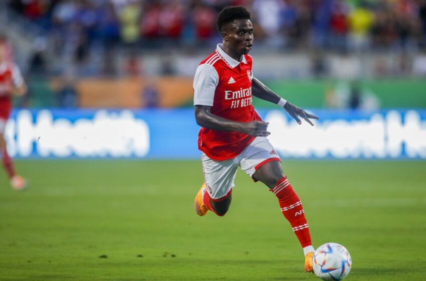 Jul 23, 2022; Orlando, FL, USA; Arsenal midfielder Bukayo Saka (7) runs with the ball against Chelsea during the first half at Camping World Stadium. Mandatory Credit: Sam Navarro-USA TODAY Sports